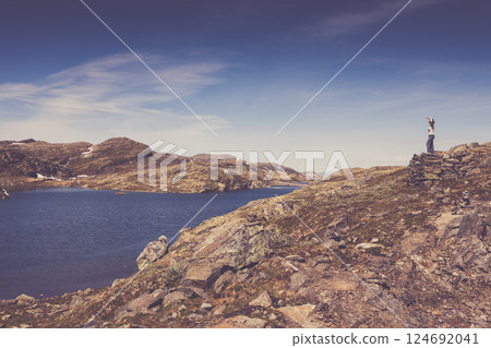 Tourist enjoying landscape norwegian nature Tourist enjoying landscape norwegian nature 124692041
