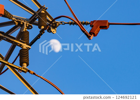 High voltage towers against blue sky High voltage towers against blue sky 124692121