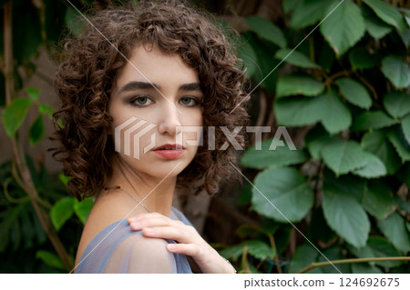 Woman with brown hair and a blue dress 124692675