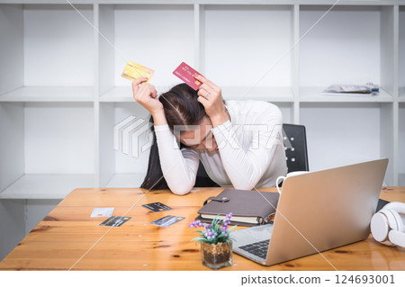 Stressful asian businesswoman with huge amount of credit card debt. 124693001