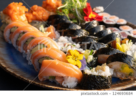 Sushi platter with assorted rolls salmon, tuna, cucumber, avocado, seaweed, rice, tempura Sushi platter with assorted rolls salmon, tuna, cucumber, avocado, seaweed, rice, tempura 124693684