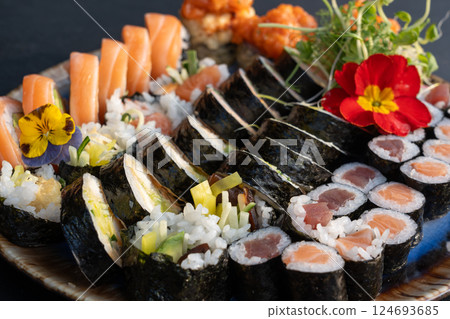 Sushi platter with assorted rolls salmon, tuna, cucumber, avocado, seaweed, rice, tempura 124693685