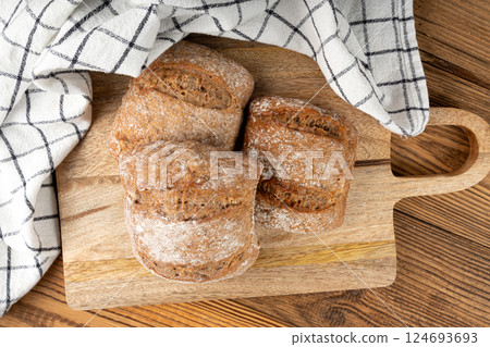 Brown rye bun, square gluten free bread, whole grain healthy breakfast bread Brown rye bun, square gluten free bread, whole grain healthy breakfast bread 124693693