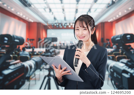 A female announcer reporting from a press conference 124695200
