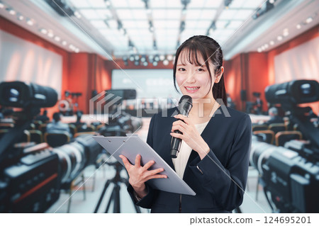 A female announcer reporting from a press conference 124695201