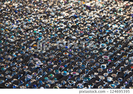 Market stall covered with hundreds of metallic rings in organized rows Market stall covered with hundreds of metallic rings in organized rows 124695395