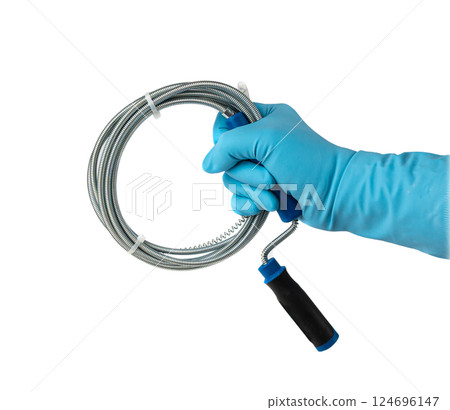Metal drain auger tool isolated, plumbing snake or cable in hands in blue glove on white background 124696147