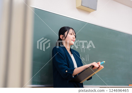 A female teacher teaching English at school A female teacher teaching English at school 124696465