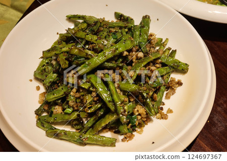 close up of Chinese stir fried green beans in Sichuan style with minced pork, garlic, spice and green beans on a white plate 124697367