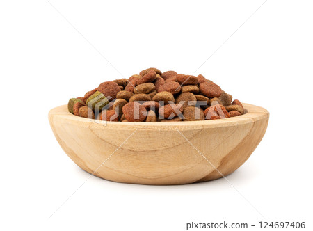 Dry pet food, dog color kibble pile, puppy meat and vegetable pellets, canine protein granules Dry pet food, dog color kibble pile, puppy meat and vegetable pellets, canine protein granules 124697406