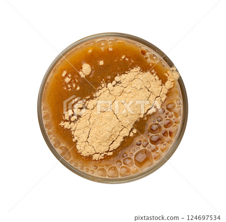 Maca powder drink isolated, dry Peruvian ginseng beverage, powder in water, ground ayak willku tea 124697534