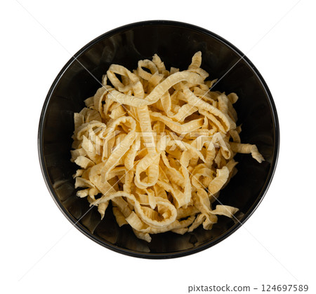 Passatelli spatzle pasta isolated, raw spaetzle noodles, dry homemade german macaroni Passatelli spatzle pasta isolated, raw spaetzle noodles, dry homemade german macaroni 124697589