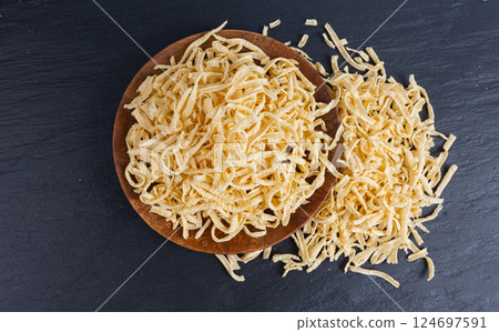 Passatelli spatzle pasta in bowl, raw spaetzle noodles, dry homemade german macaroni 124697591