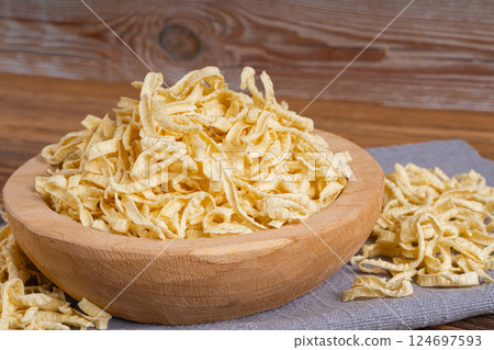 Passatelli spatzle pasta in bowl, raw spaetzle noodles, dry homemade german macaroni 124697593