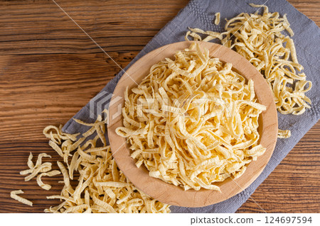 Passatelli spatzle pasta in bowl, raw spaetzle noodles, dry homemade german macaroni Passatelli spatzle pasta in bowl, raw spaetzle noodles, dry homemade german macaroni 124697594
