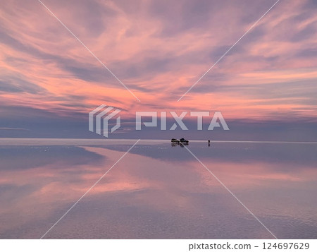 Sunset pink surreal sky clouds above lake water 124697629