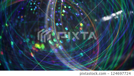Holiday shining. Defocused futuristic flare. Multicolor bright gleaming particles lens glow motion on abstract bokeh light blurred background. 124697724