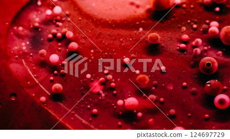 Ink liquid. Paint bubbles. Defocused red pink color round drops blob texture in water mix wave flow abstract art background. 124697729