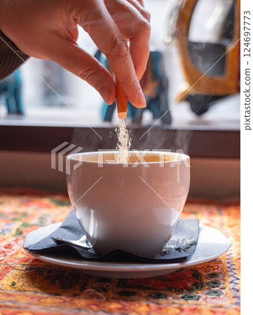 Masala chai an Indian restaurant, spiced milk tea, traditional cardamom hot drink with spices 124697773