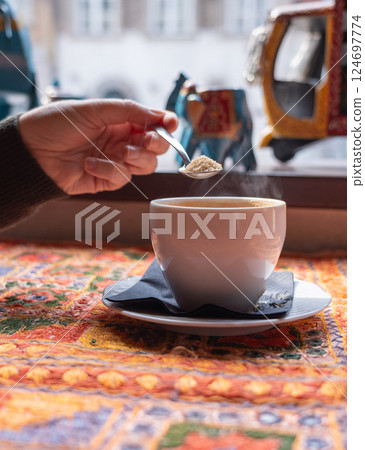 Masala chai an Indian restaurant, spiced milk tea, traditional cardamom hot drink with spices 124697774