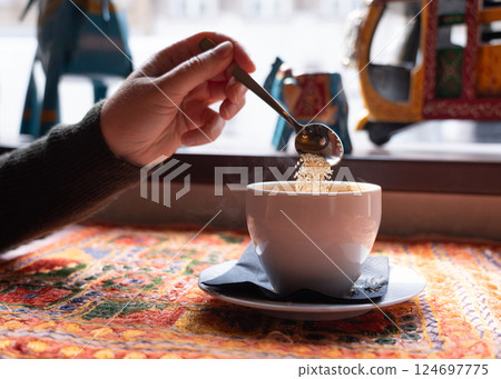 Masala chai an Indian restaurant, spiced milk tea, traditional cardamom hot drink with spices 124697775