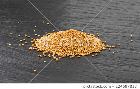 Mustard seeds isolated, dry yellow sinapis alba grains, mostarde balls Mustard seeds isolated, dry yellow sinapis alba grains, mostarde balls 124697818