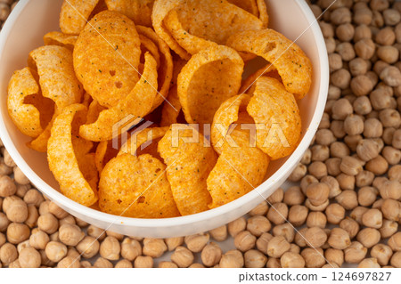 Hummus chickpea chips, chick pea crisps pile, healthy orange snack, fried legume crunchies 124697827