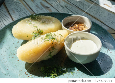 Lithuanian potato dumplings, cepelinai pancakes or kolduny, meat stuffed draniki, traditional didzkukuliai Lithuanian potato dumplings, cepelinai pancakes or kolduny, meat stuffed draniki, traditional didzkukuliai 124697944