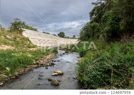 The riverbank of Ylang Ylang River in Cavite, Philippines at a low water level The riverbank of Ylang Ylang River in Cavite, Philippines at a low water level 124697956