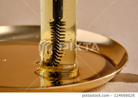Bottle with brush filled with oil for eyebrow and eyelash growth. Texture. Bottle with brush filled with oil for eyebrow and eyelash growth. Texture. 124698026