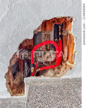 Exposed Plumbing Pipes in Damaged Wall, Construction Repair, Home Maintenance Work. High quality photo 124698064