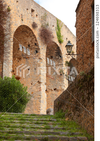 Stone steps between medieval walls of houses in bay of Porto Venere, Liguria. Tourism in Italy. Traditional buildings. Background for design. Stone steps between medieval walls of houses in bay of Porto Venere, Liguria. Tourism in Italy. Traditional buildings. Background for design. 124698313