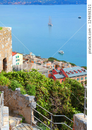 Yachts, boats in bay of Porto Venere, Liguria. Sea and tourism in Italy. Traditional buildings. Background for design.  124698321