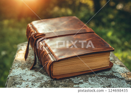 Vintage leather bound journal rests on table Vintage leather bound journal rests on table 124698435