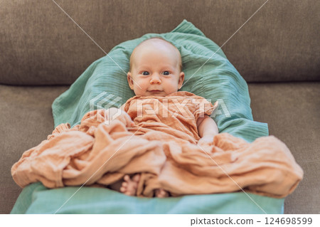 Newborn baby comfortably resting in a cozy baby nest. Safe and peaceful sleep concept for infants Newborn baby comfortably resting in a cozy baby nest. Safe and peaceful sleep concept for infants 124698599