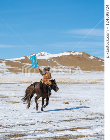 boy with the Flag of Kazakhstan in his hand ride a horse 124698724