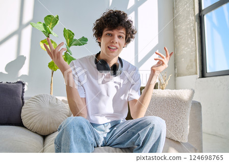 Young guy university student talking looking in web camera, at home Young guy university student talking looking in web camera, at home 124698765