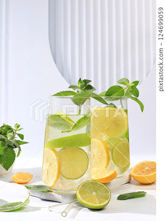 Diet vegan cocktail with citrus, detox water, mojito with lemon, lime, orange, mint and green apple. Detox diet and weight loss concept, healthy lifestyle advertising, menu for cafe and restaurant. Diet vegan cocktail with citrus, detox water, mojito with lemon, lime, orange, mint and green apple. Detox diet and weight loss concept, healthy lifestyle advertising, menu for cafe and restaurant. 124699059