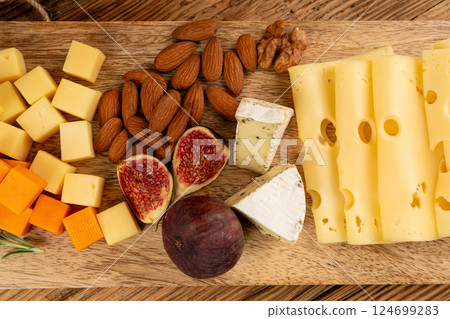 Cheese plate of color cheeses variety, yellow, white and blue cheese board, assorted dairy products Cheese plate of color cheeses variety, yellow, white and blue cheese board, assorted dairy products 124699283