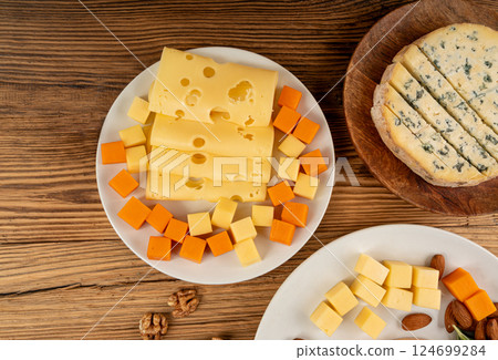 Cheese plate of color cheeses variety, yellow, white and blue cheese board, assorted dairy products 124699284