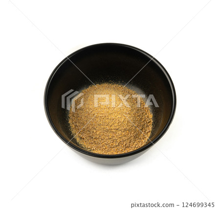 Ground fenugreek seeds in black bowl, milled dry trigonella powder, spicy methi dana pounded Ground fenugreek seeds in black bowl, milled dry trigonella powder, spicy methi dana pounded 124699345