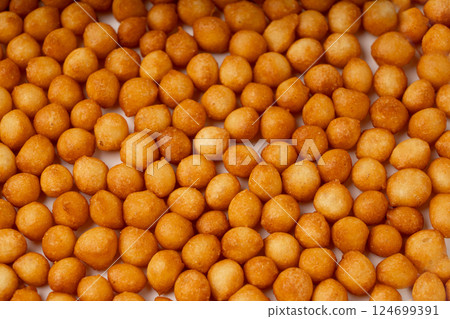 Small pastry balls, fried crispy wheat soup pearls, salad egg puffs or choux pastry 124699391