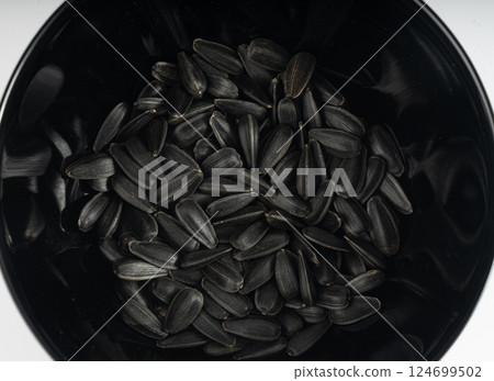 Sunflower seeds pile isolated, black oil sun flower grains group with shell, fresh edible oil seeds heap Sunflower seeds pile isolated, black oil sun flower grains group with shell, fresh edible oil seeds heap 124699502