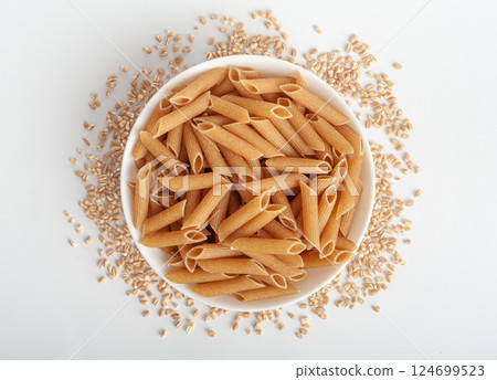 Raw Brown Pasta, Wholegrain Penne, Dry Whole Grain Noodle, Raw Spelt Macaroni, Healthy Italy Food Raw Brown Pasta, Wholegrain Penne, Dry Whole Grain Noodle, Raw Spelt Macaroni, Healthy Italy Food 124699523