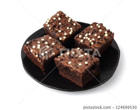 Chocolate brownie cake sprinkled with white and dark balls, classic birthday brownie square piece 124699530