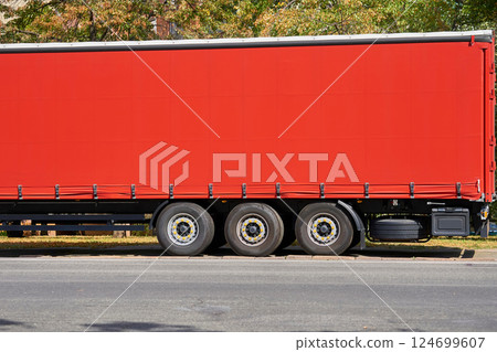 Delivery. Heavy red trailer for long distance transportation.Place for text Delivery. Heavy red trailer for long distance transportation.Place for text 124699607