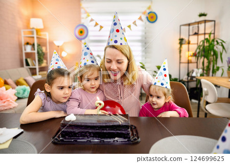 Celebrating a joyful birthday with loved ones at home Celebrating a joyful birthday with loved ones at home 124699625