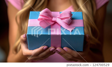 Woman hands holding blue gift satin ribbon, shopping Valentines, New Year, Mothers, Christmas 124700529