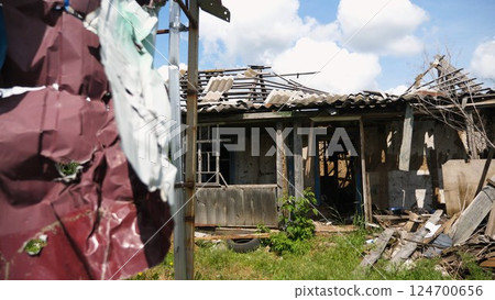 View to destroyed residential buildings at Kharkivska oblast. Ruined houses after bomb attacks on ukrainian territory from russia army. Consequences of russian invasion of Ukraine. Slow motion 124700656