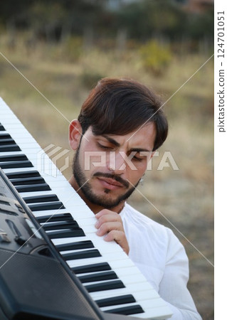 Italian Boy Walks Playing Musical Keyboard On Shoulder In Nature Calabria 124701051